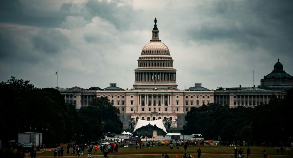 white concrete building under gray clouds during daytime